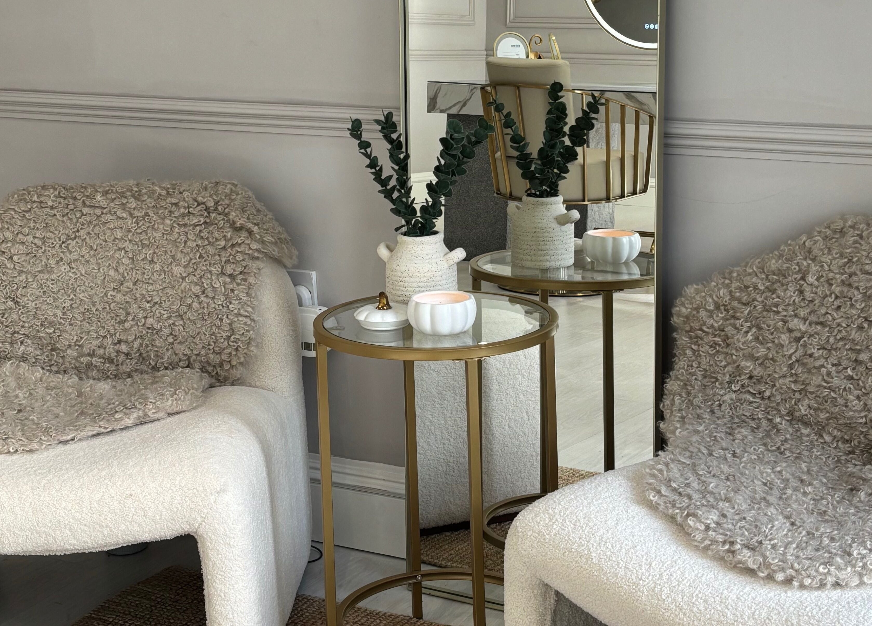 Elegant seating area at Secret Salon, Pucklechurch, England, GB with soft chairs and decorative elements.