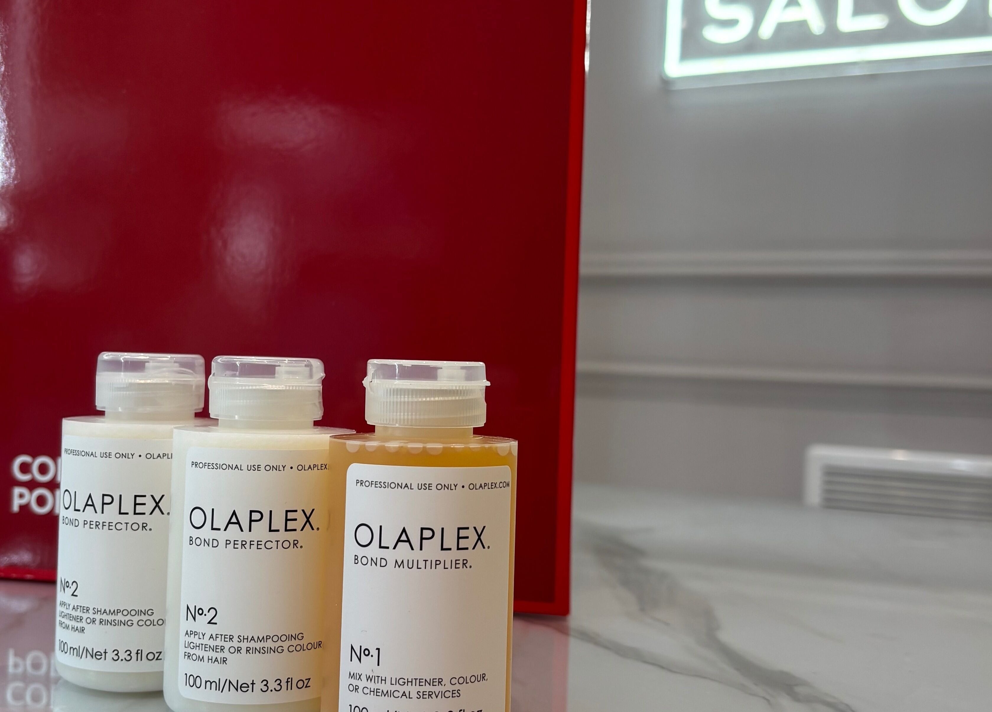 Olaplex hair products showcased at Secret Salon, Pucklechurch, England, GB on elegant marble countertop.