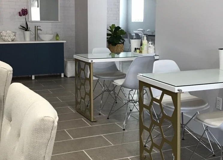 Chic interior of Top Coat Nail Studio in Bryn Mawr, Pennsylvania, US featuring modern nail tables and comfy chairs.