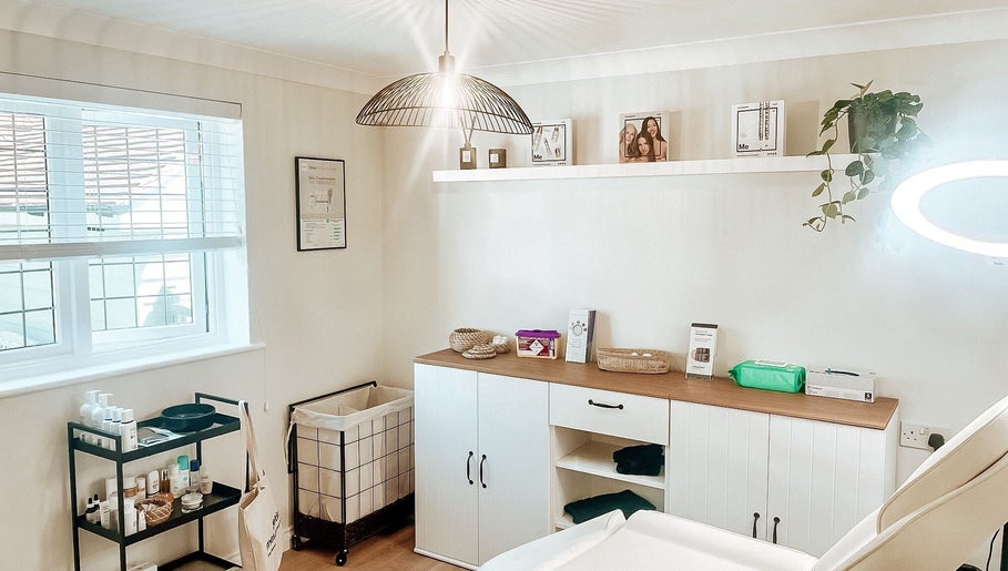 Bright, serene treatment room at The Coggeshall Skin Clinic in Coggeshall, England, GB, with skincare products.