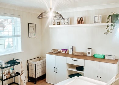 Bright, serene treatment room at The Coggeshall Skin Clinic in Coggeshall, England, GB, with skincare products.