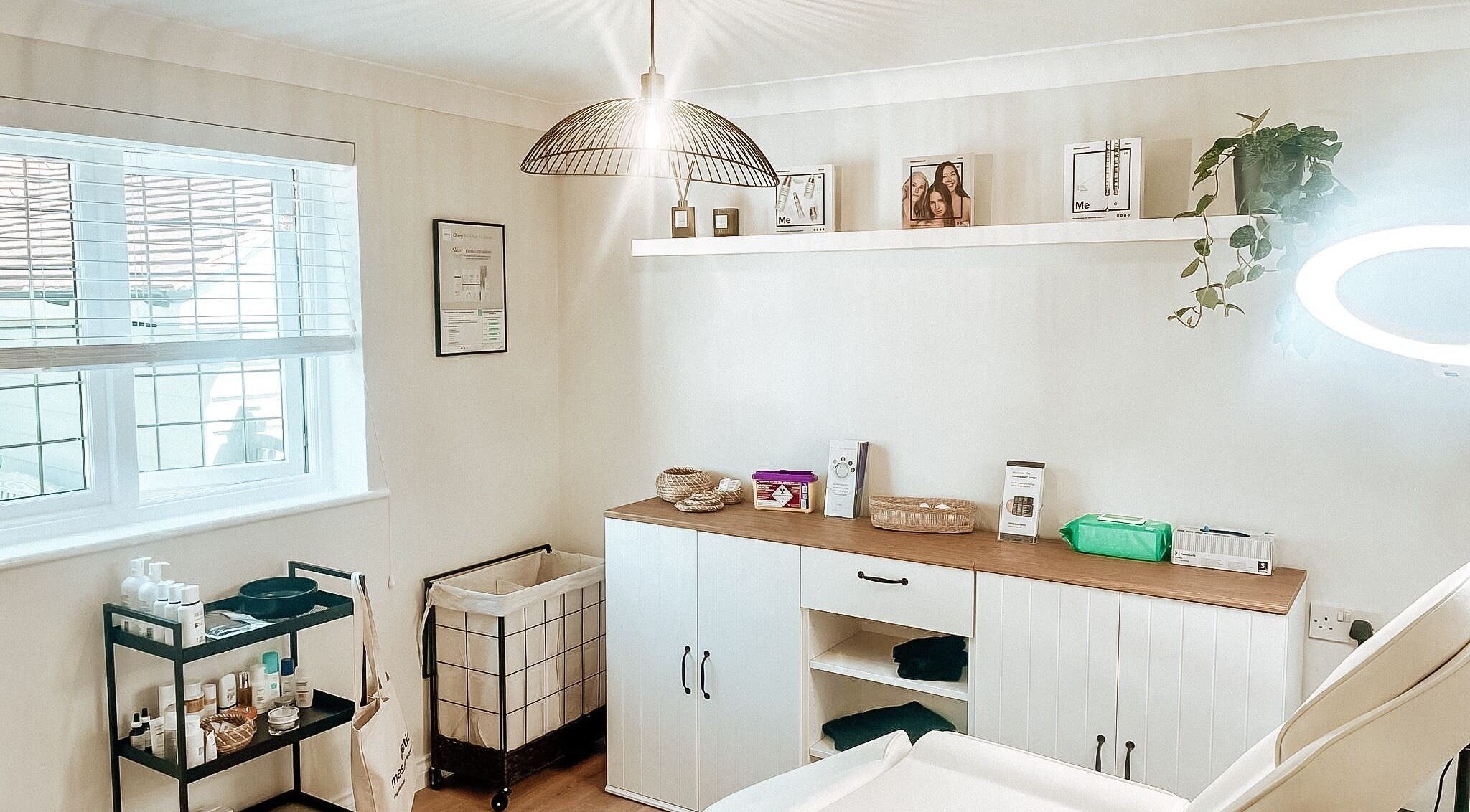 Bright, serene treatment room at The Coggeshall Skin Clinic in Coggeshall, England, GB, with skincare products.
