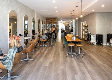 Interior of Coogee Hair & Body Boutique in Coogee, New South Wales, AU, featuring modern salon chairs and mirrors.