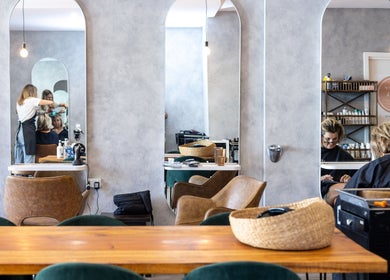 Coogee Hair & Body Boutique modern interior in Coogee, New South Wales, AU, showcasing stylish salon chairs and mirrors.
