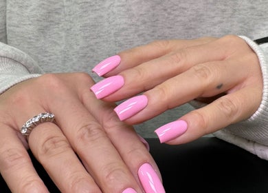 Pink manicured nails at Marta Beauty Salon and Academy, London, England, GB. Perfect for a chic style.