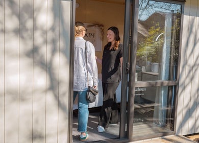 Customer greeted warmly at Bloom Boutique Beauty's entrance in Dunedin, Otago, NZ on a sunny day.