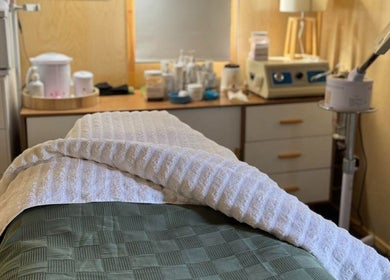Relaxing treatment room at Bloom Boutique Beauty, Dunedin, Otago, NZ equipped with spa essentials.
