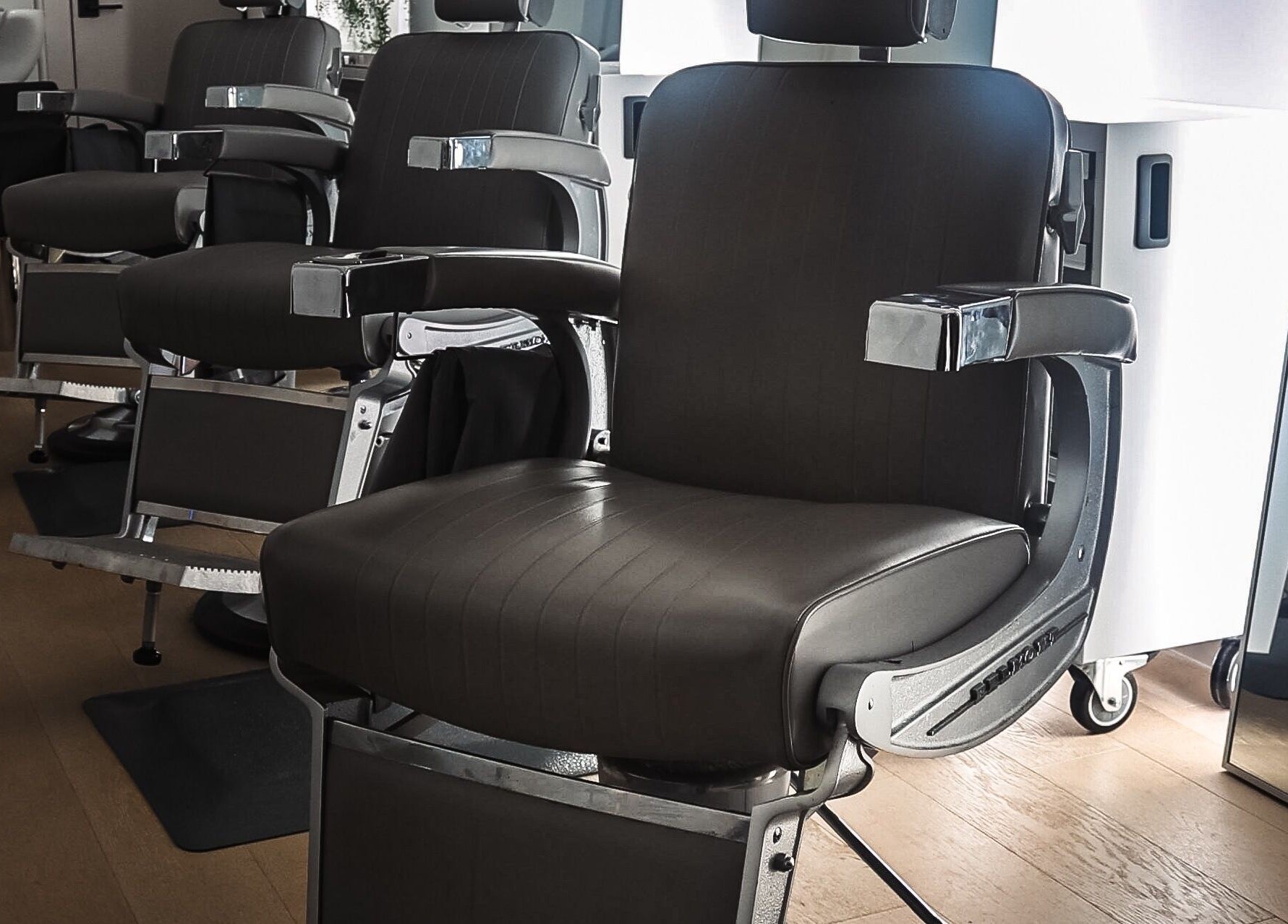 Modern barber chairs at CABELLO BROOKLYN salon, New York, New York, US, showcasing sleek design and comfort.