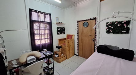 Cozy beauty room at The Glamorium, Cultuurtuin, Paramaribo, SR, featuring a massage chair and floral decor.