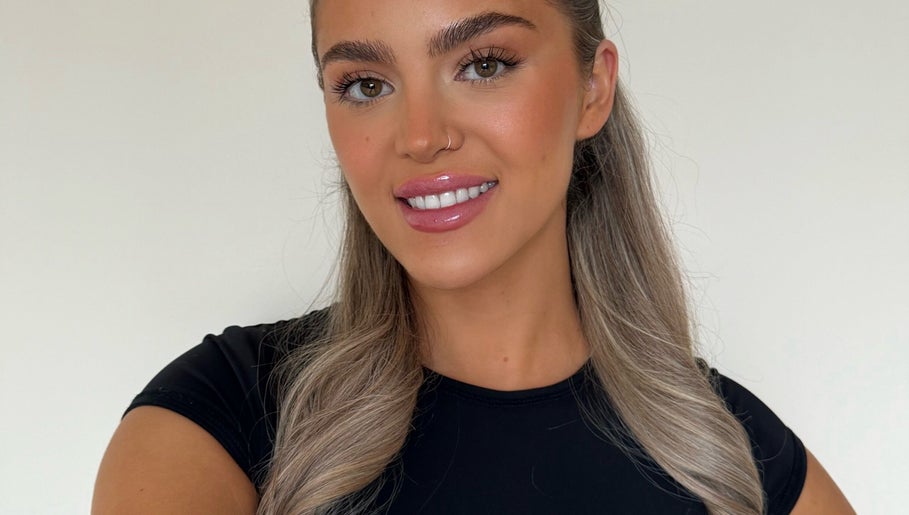 Smiling woman with flawless makeup at Skin Aesthetics by Becki in Truro, England, GB.