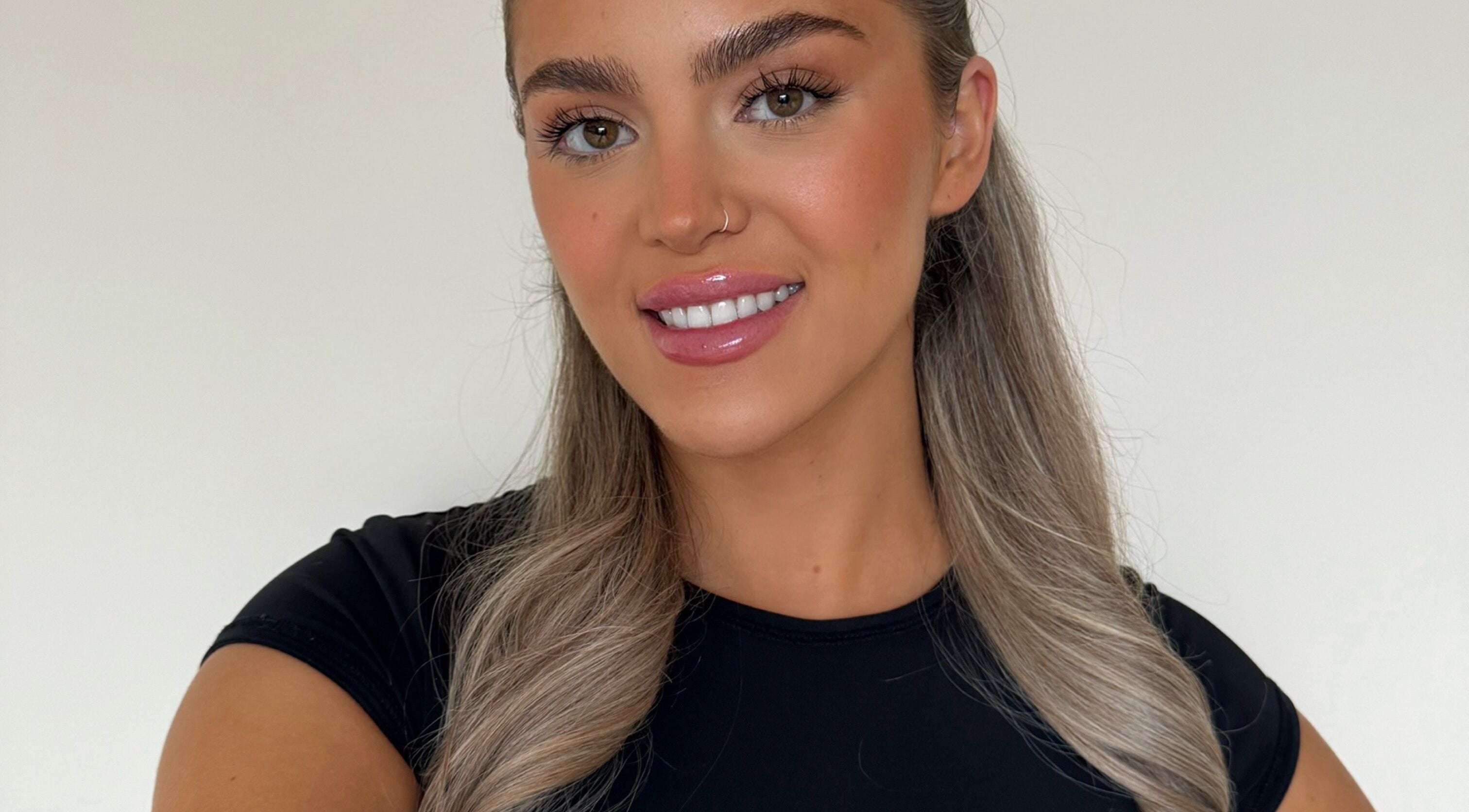 Smiling woman with flawless makeup at Skin Aesthetics by Becki in Truro, England, GB.