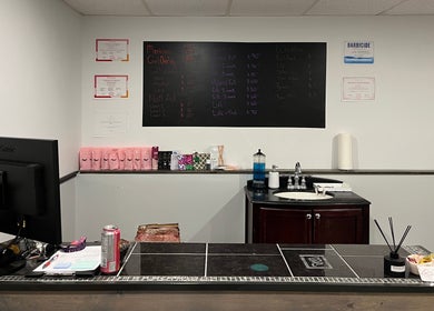 Reception area at True North Esthetics in Terrace Bay, Ontario, CA featuring beauty services menu and decor.