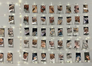 Photo wall showcasing nail art at True North Esthetics, Terrace Bay, Ontario, CA, with delicate lighting.