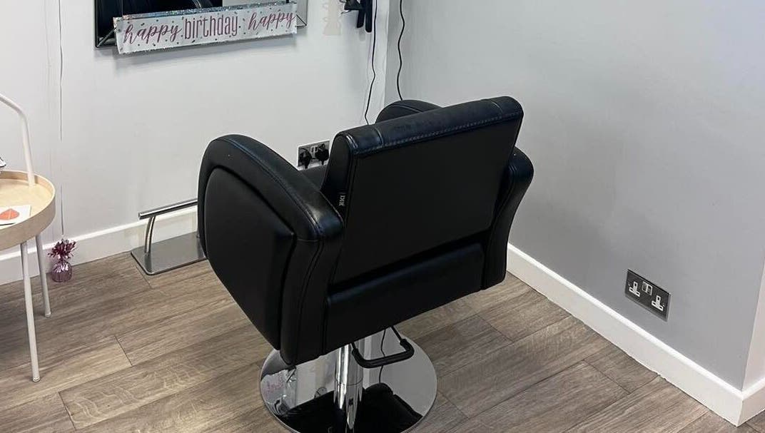 Modern salon chair at Hair at 12b, Seaton, England, GB offering comfort and style.