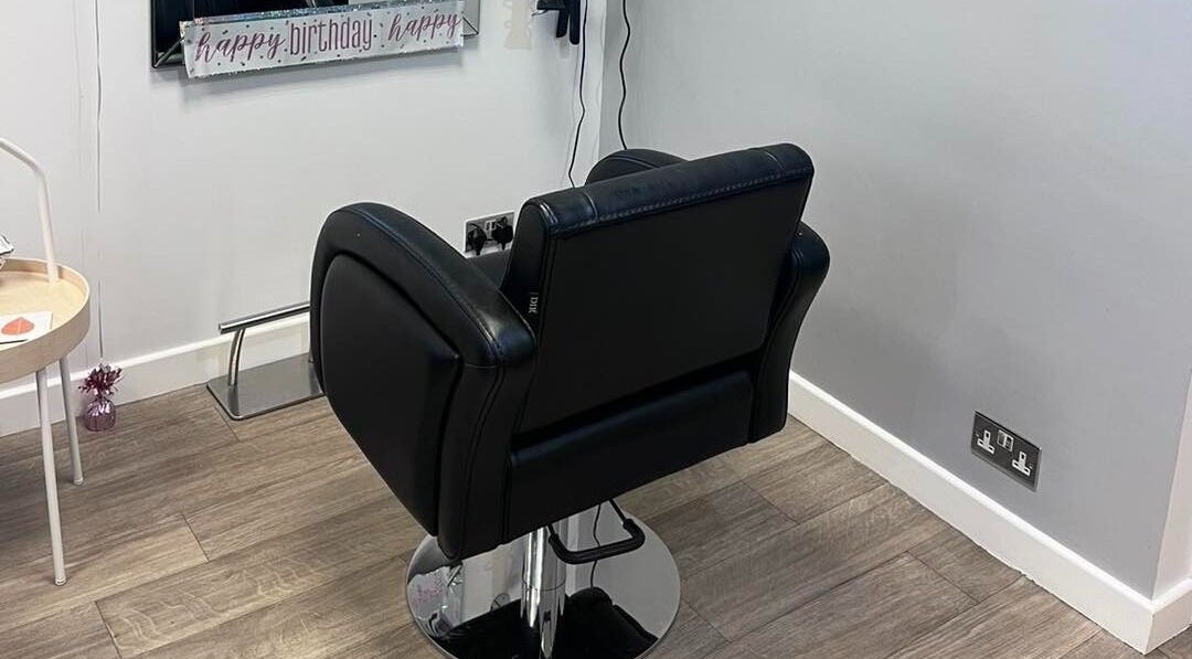 Modern salon chair at Hair at 12b, Seaton, England, GB offering comfort and style.
