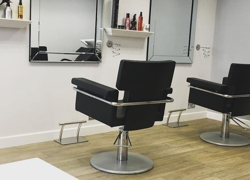 Modern salon chairs at Hair at 12b, Seaton, England, GB, showcasing stylish interior and sleek design.