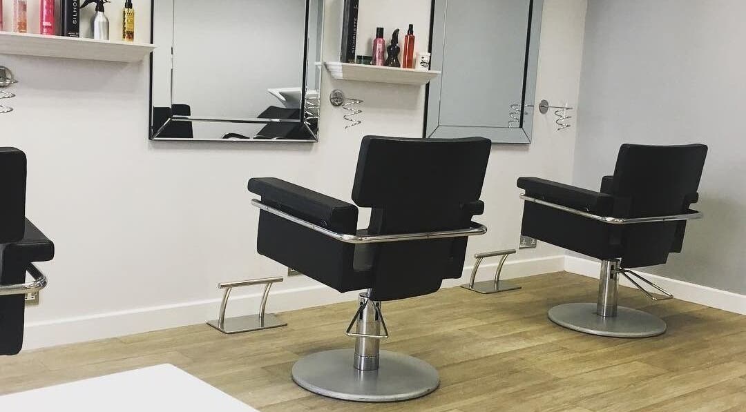 Modern salon chairs at Hair at 12b, Seaton, England, GB, showcasing stylish interior and sleek design.