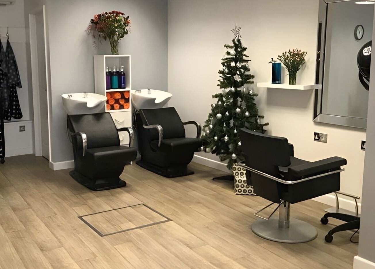 Cozy salon interior at Hair at 12b in Seaton, England, GB, featuring stylish chairs and holiday decor.