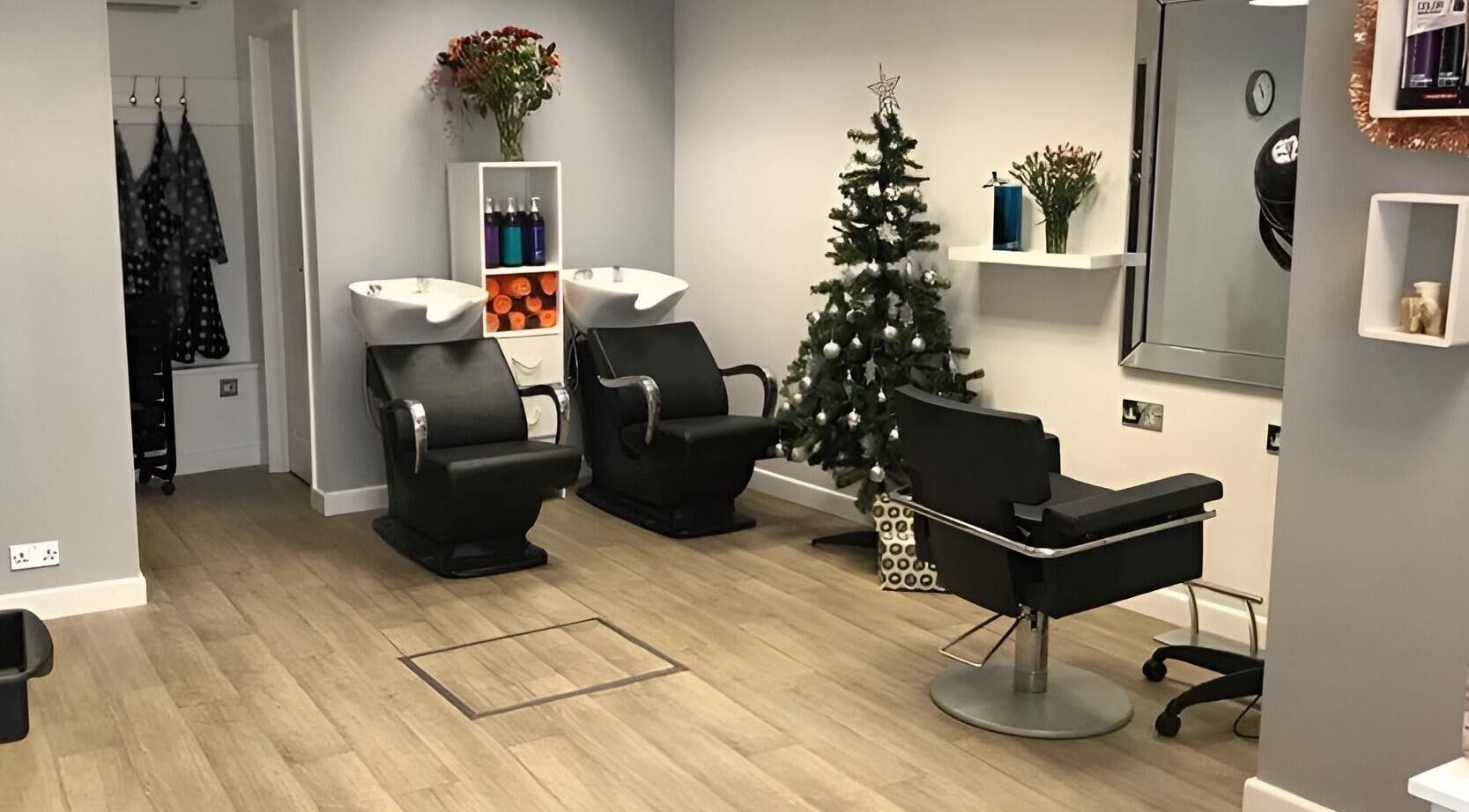 Cozy salon interior at Hair at 12b in Seaton, England, GB, featuring stylish chairs and holiday decor.