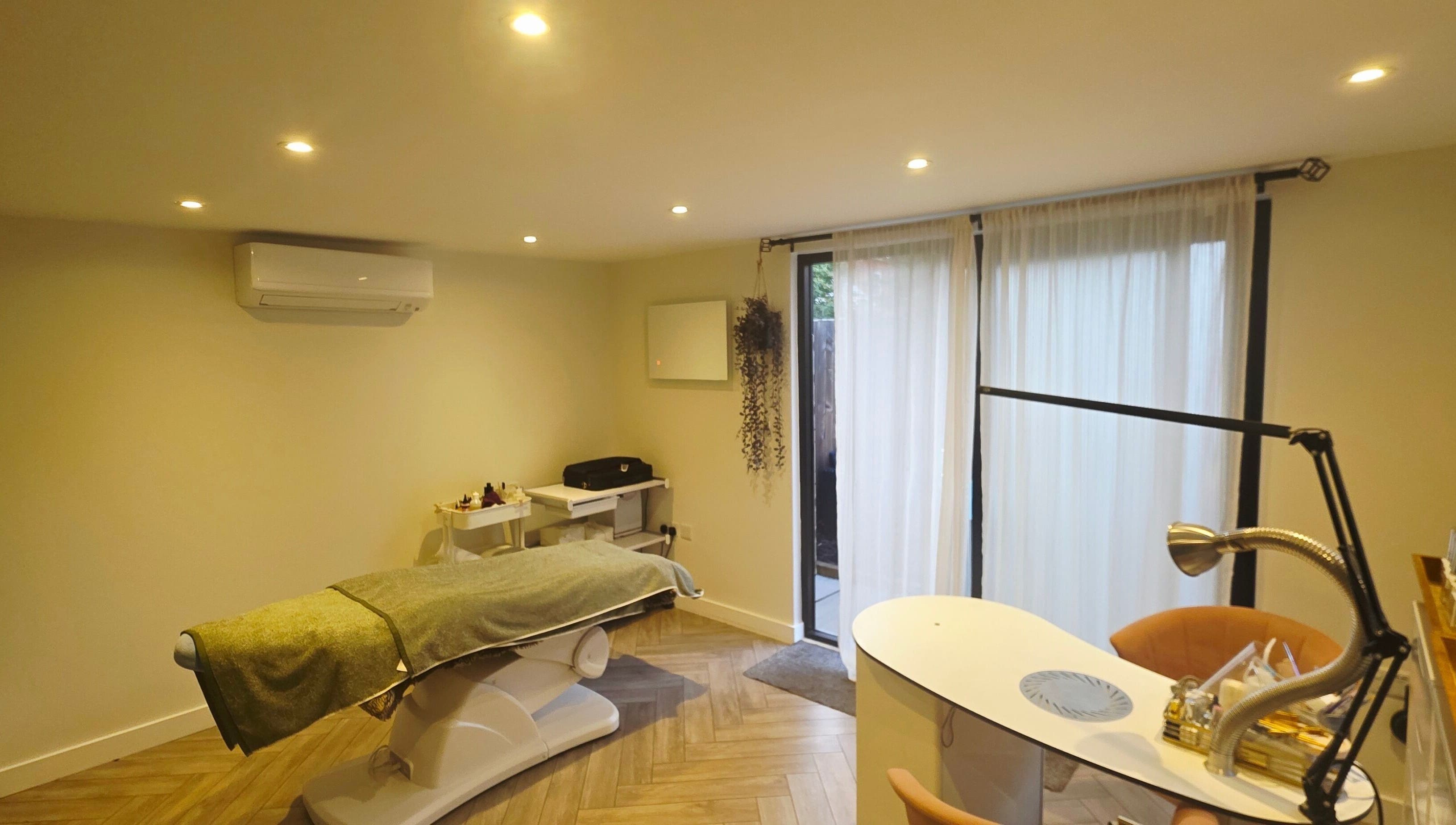 Tranquil treatment room at Nicola's Nails and Beauty, Whitchurch, England, GB, with a spa bed and manicure station.