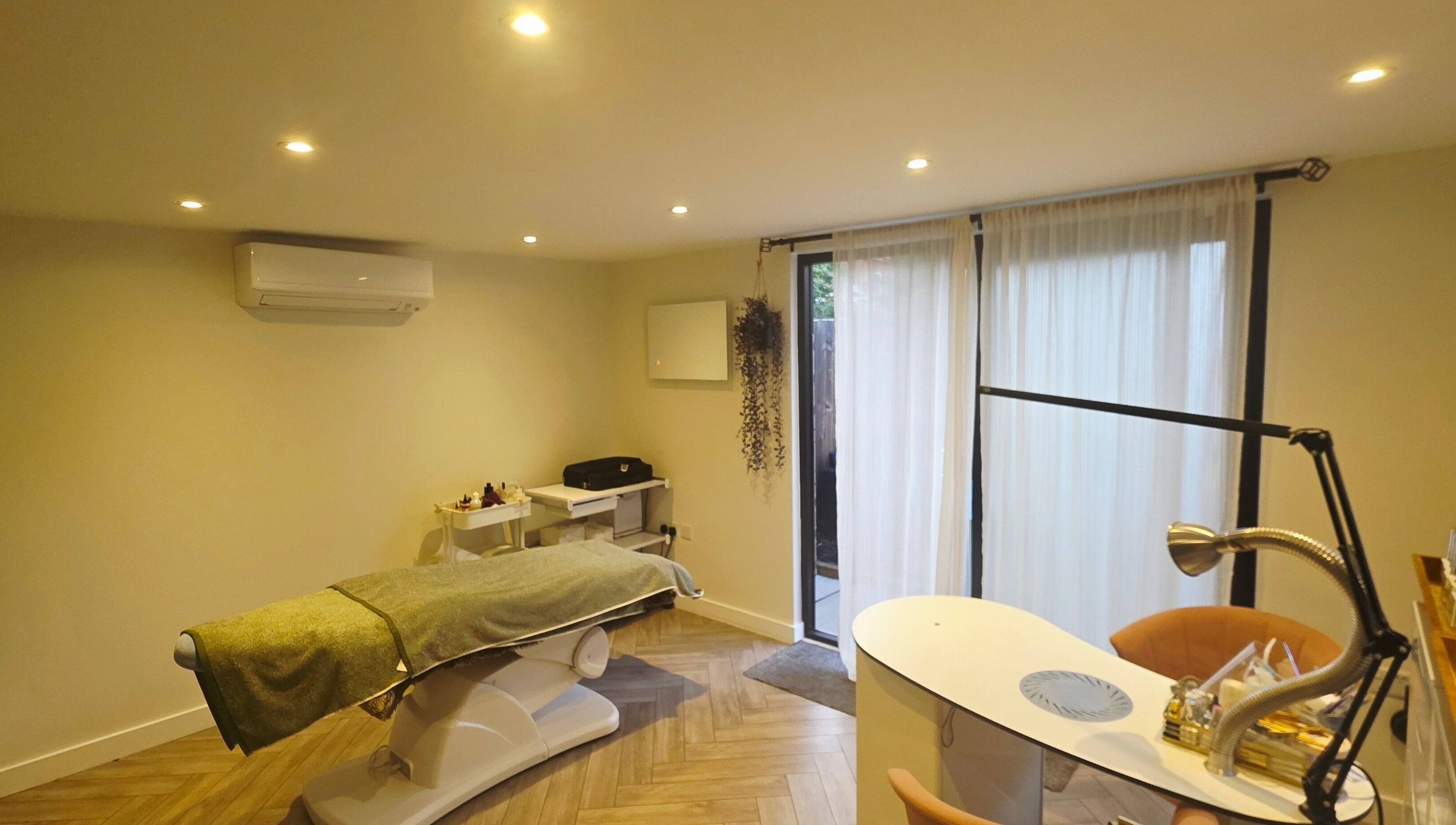 Tranquil treatment room at Nicola's Nails and Beauty, Whitchurch, England, GB, with a spa bed and manicure station.