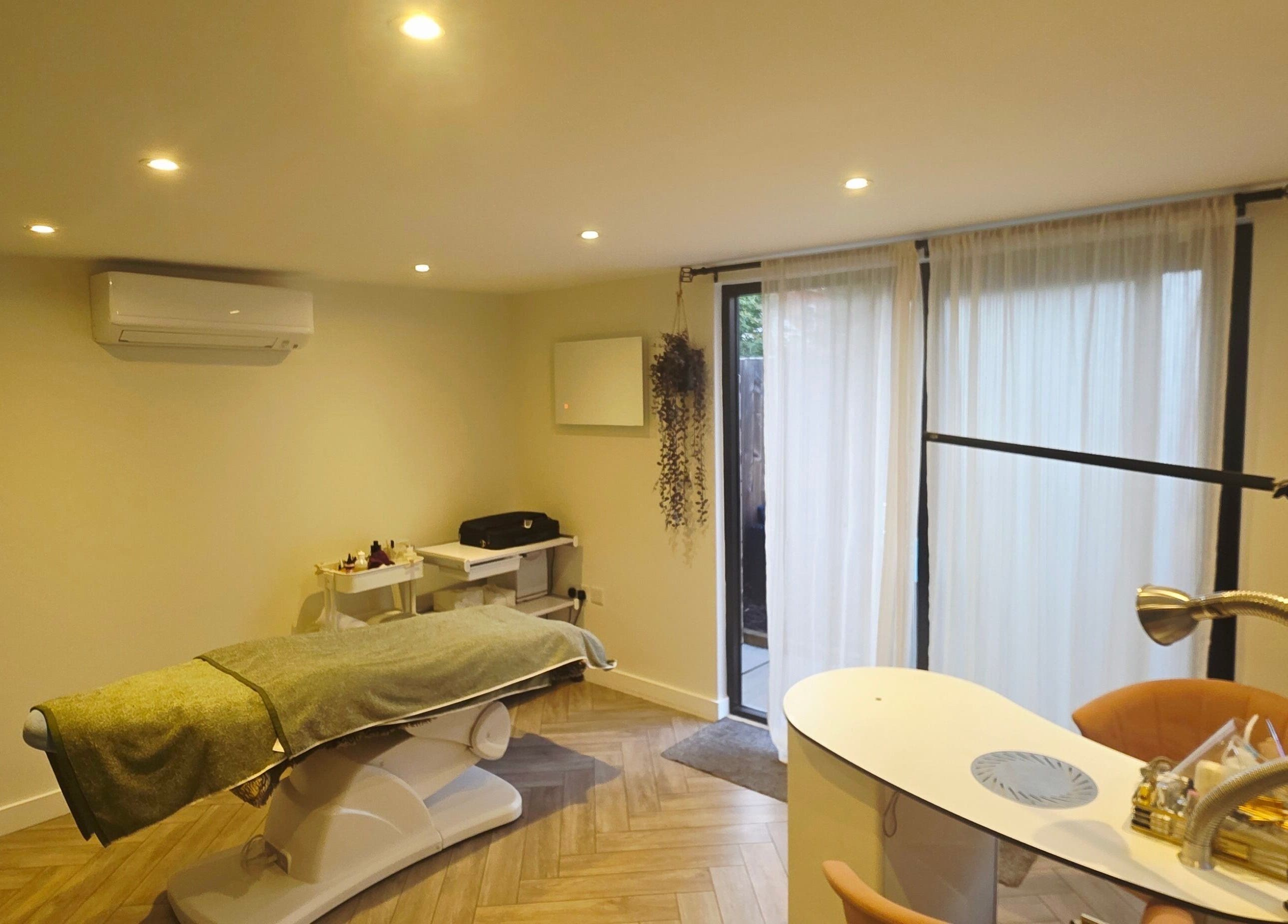 Tranquil treatment room at Nicola's Nails and Beauty, Whitchurch, England, GB, with a spa bed and manicure station.