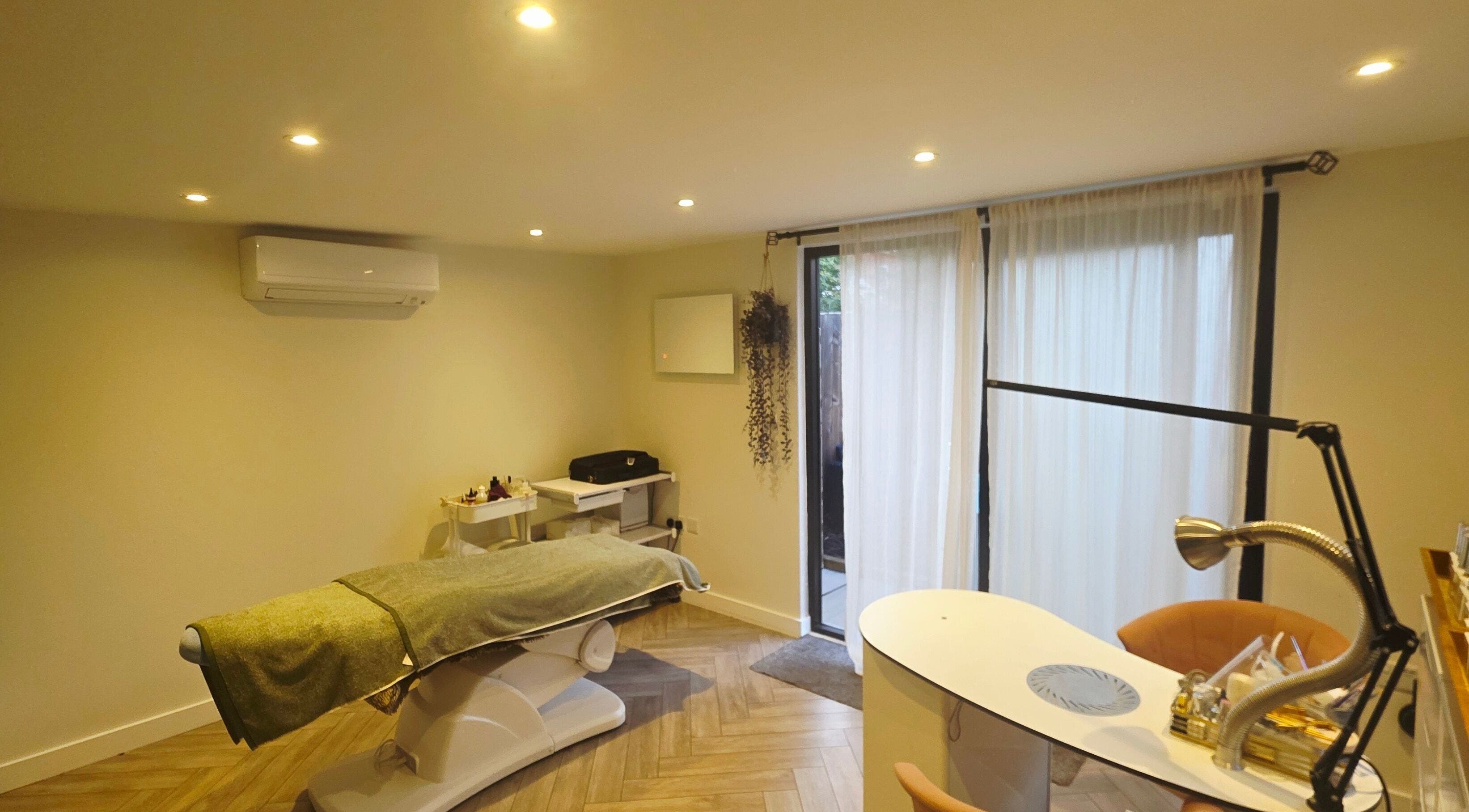 Tranquil treatment room at Nicola's Nails and Beauty, Whitchurch, England, GB, with a spa bed and manicure station.