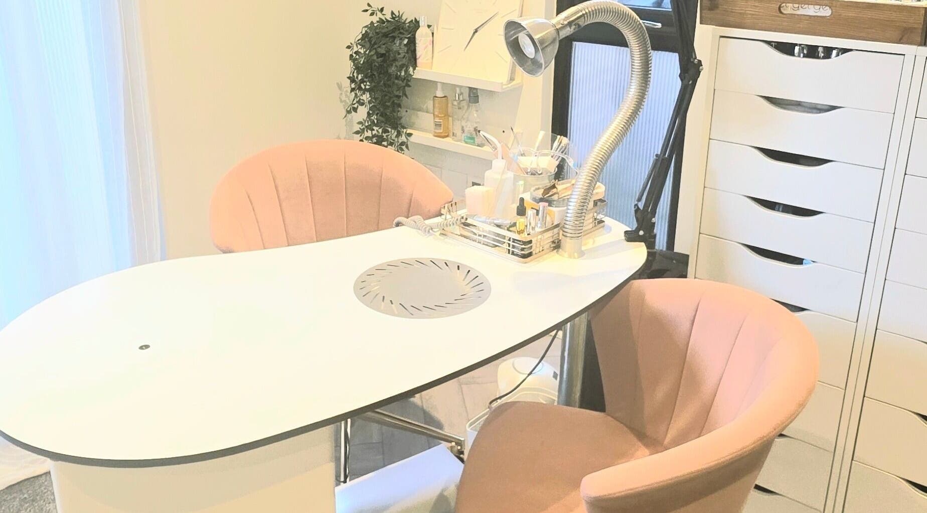 Stylish nail station at Nicola's Nails and Beauty in Whitchurch, England, GB with plush chairs and modern decor.