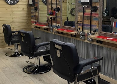 Stylish barber chairs at The Barber Shack, Saint Martin's, England, GB. Rustic wooden decor adds charm.