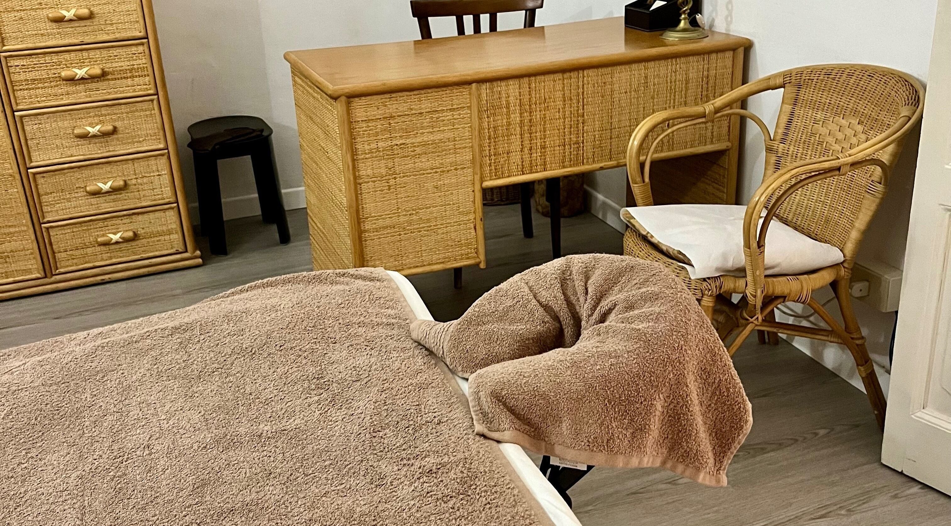 Interno rilassante di SpaToYou - on Demand a Cernobbio, Lombardia, IT, con mobili in rattan e lettino da massaggio.