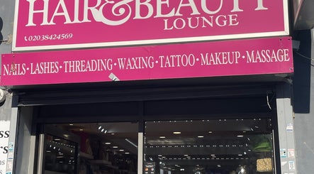 Exterior of Glammy Beauty, London, England, GB, showcasing its vibrant pink beauty lounge signage.