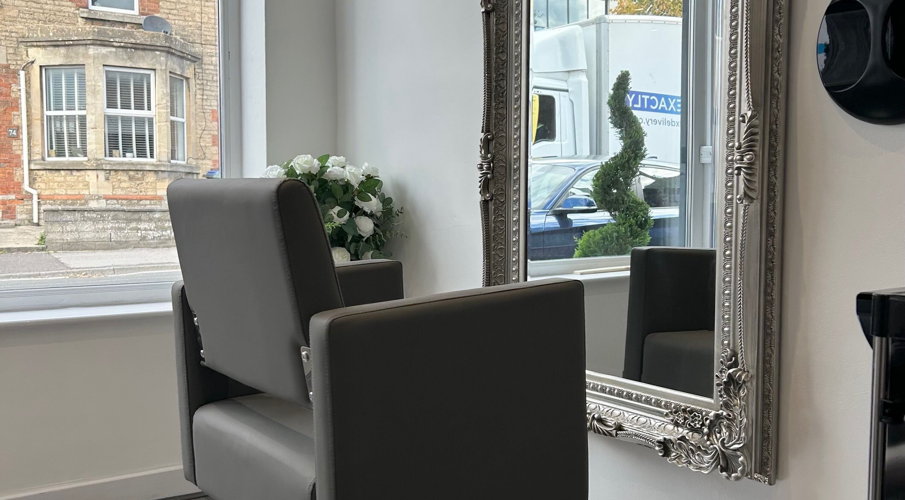 Elegant salon chair and ornate mirror at Prestige Hair Salon in Chippenham, England, GB.