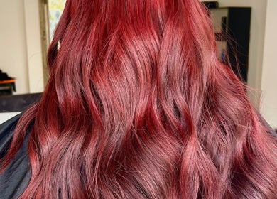 Vibrant red hair waves at Prestige Hair Salon, Chippenham, England, GB, showcasing expert colouring technique.
