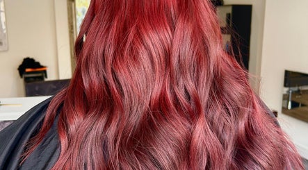 Vibrant red hair waves at Prestige Hair Salon, Chippenham, England, GB, showcasing expert colouring technique.