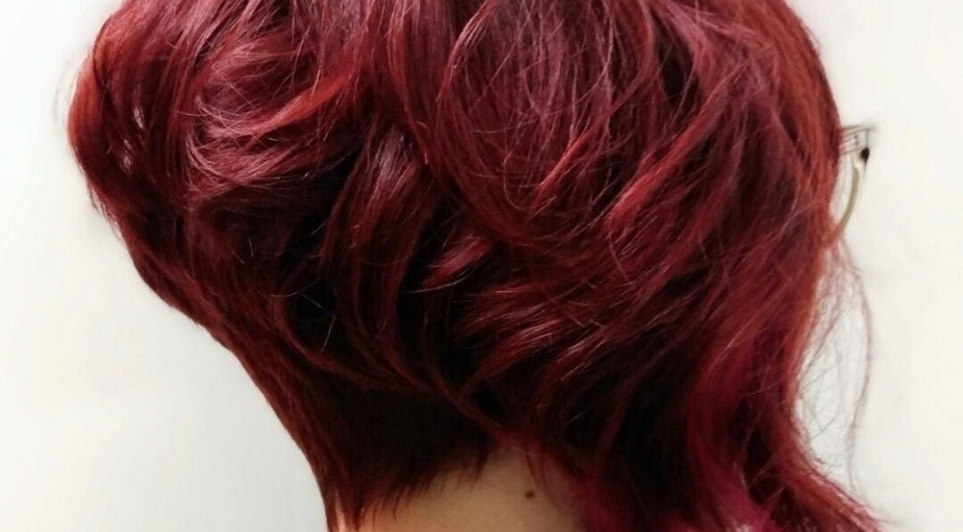 Vibrant red hairstyle from Jonny Styles in Austin, Texas, US showcases rich color and expert styling.