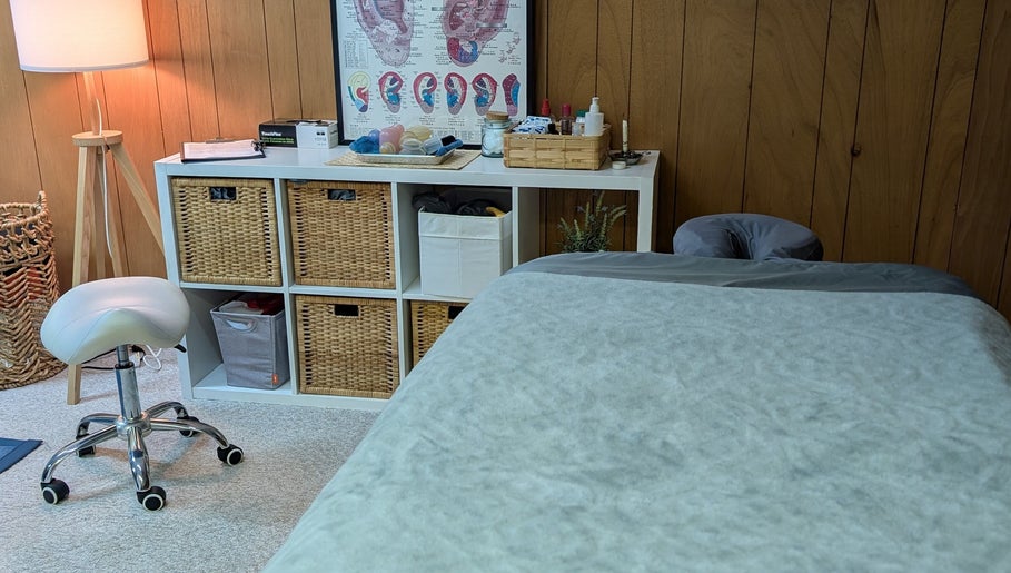 Cozy therapy room at Alyssa Acupuncture & TCM in Edmonton, Alberta, CA with massage table and wooden decor.