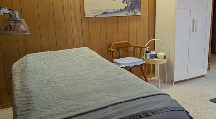 Calm therapy room at Alyssa Acupuncture & TCM, Edmonton, Alberta, CA with massage bed and ambient decor.