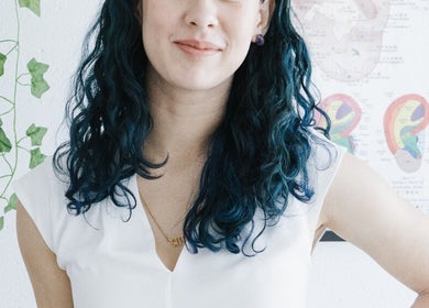 Alyssa Acupuncture & TCM in Edmonton, Alberta, CA features an acupuncturist with blue hair and ear chart poster.
