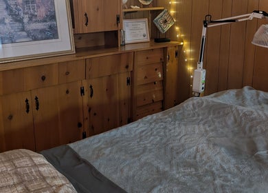 Warm, inviting treatment room at Alyssa Acupuncture & TCM in Edmonton, Alberta, CA with wooden decor and soft lighting.