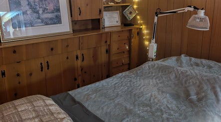 Warm, inviting treatment room at Alyssa Acupuncture & TCM in Edmonton, Alberta, CA with wooden decor and soft lighting.