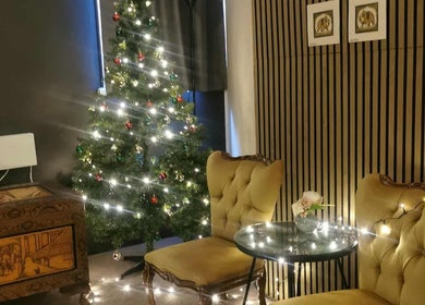 Cozy holiday decor at Chang Thai Massage, Ipswich, Queensland, AU with elegant chairs and a lit Christmas tree.
