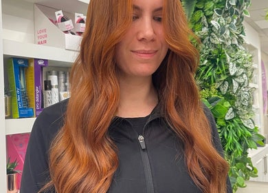 Flowing red hair styled at Aimee Rose Hair, Stockton-on-Tees, England, GB, in a natural, vibrant setting.