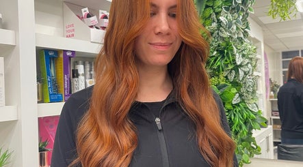 Flowing red hair styled at Aimee Rose Hair, Stockton-on-Tees, England, GB, in a natural, vibrant setting.