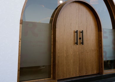 Wooden arched entry of Tribes Men's Spa & Salon (Mazoon st), Muscat, Muscat Governorate, OM.