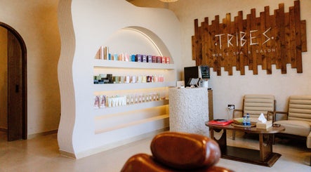 Interior of Tribes Men's Spa & Salon (Mazoon St) in Muscat, showcasing product shelves and seating area.