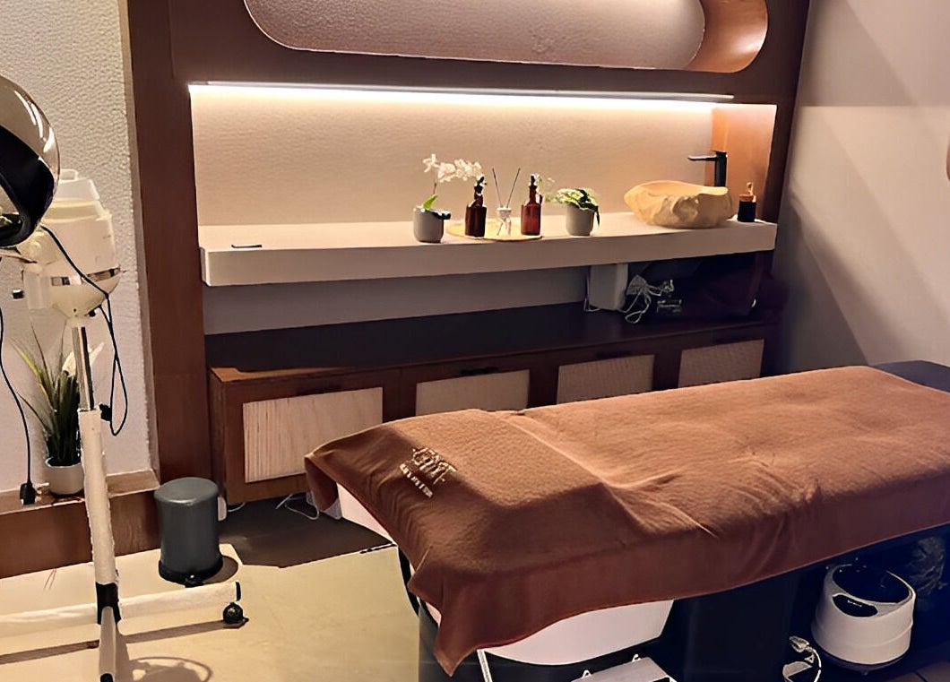 Luxurious spa room at Tribes Men's Spa & Salon (Mazoon st), Muscat with a treatment bed and elegant decor.