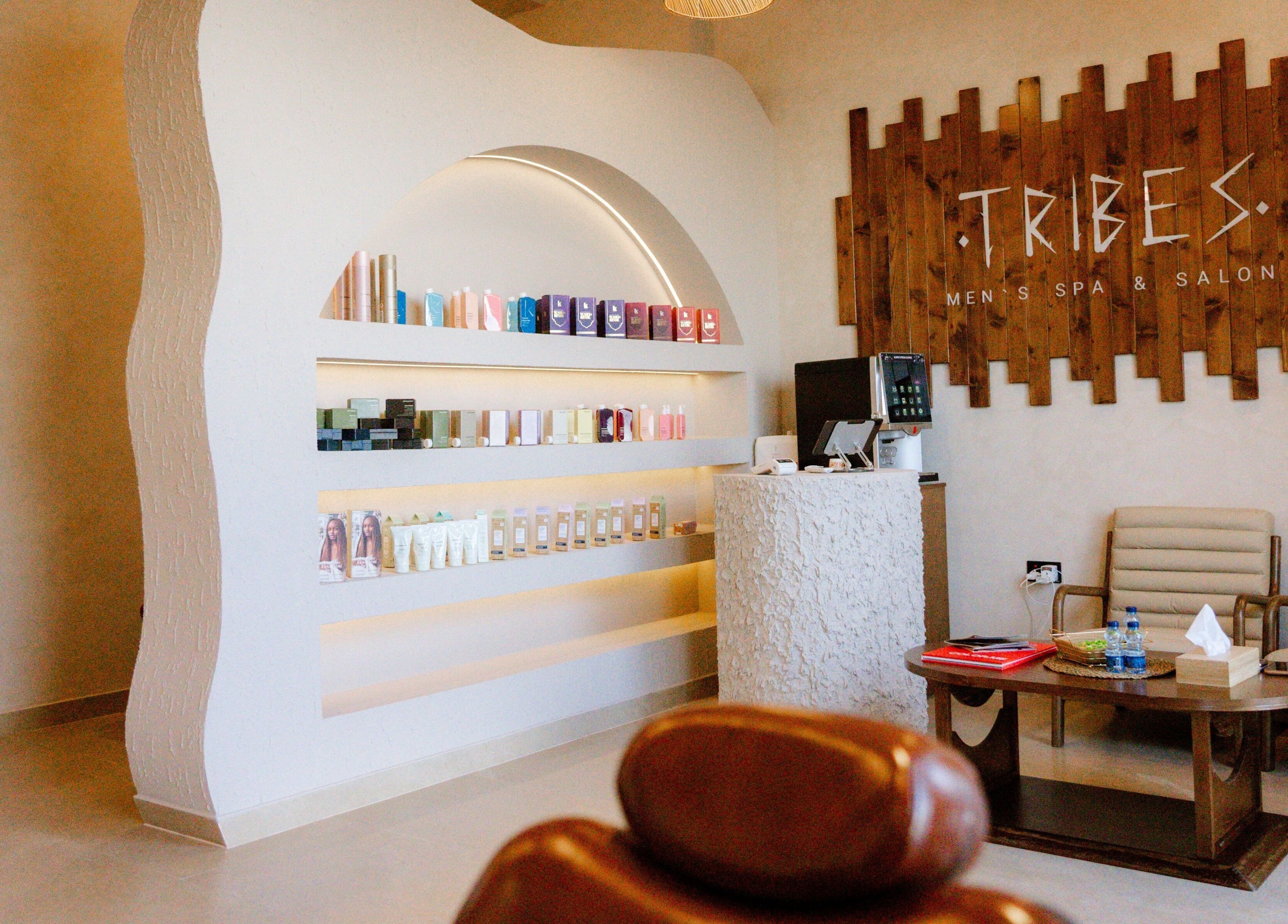 Stylish interior of Tribes Men's Spa & Salon (Mazoon st), Muscat, Muscat Governorate, OM with product shelves.