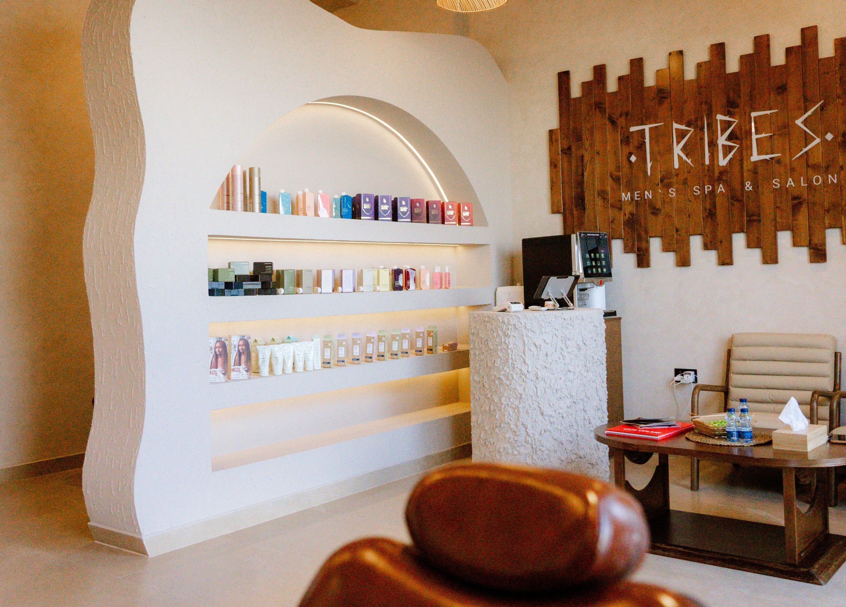 Stylish interior of Tribes Men's Spa & Salon (Mazoon st), Muscat, Muscat Governorate, OM with product shelves.