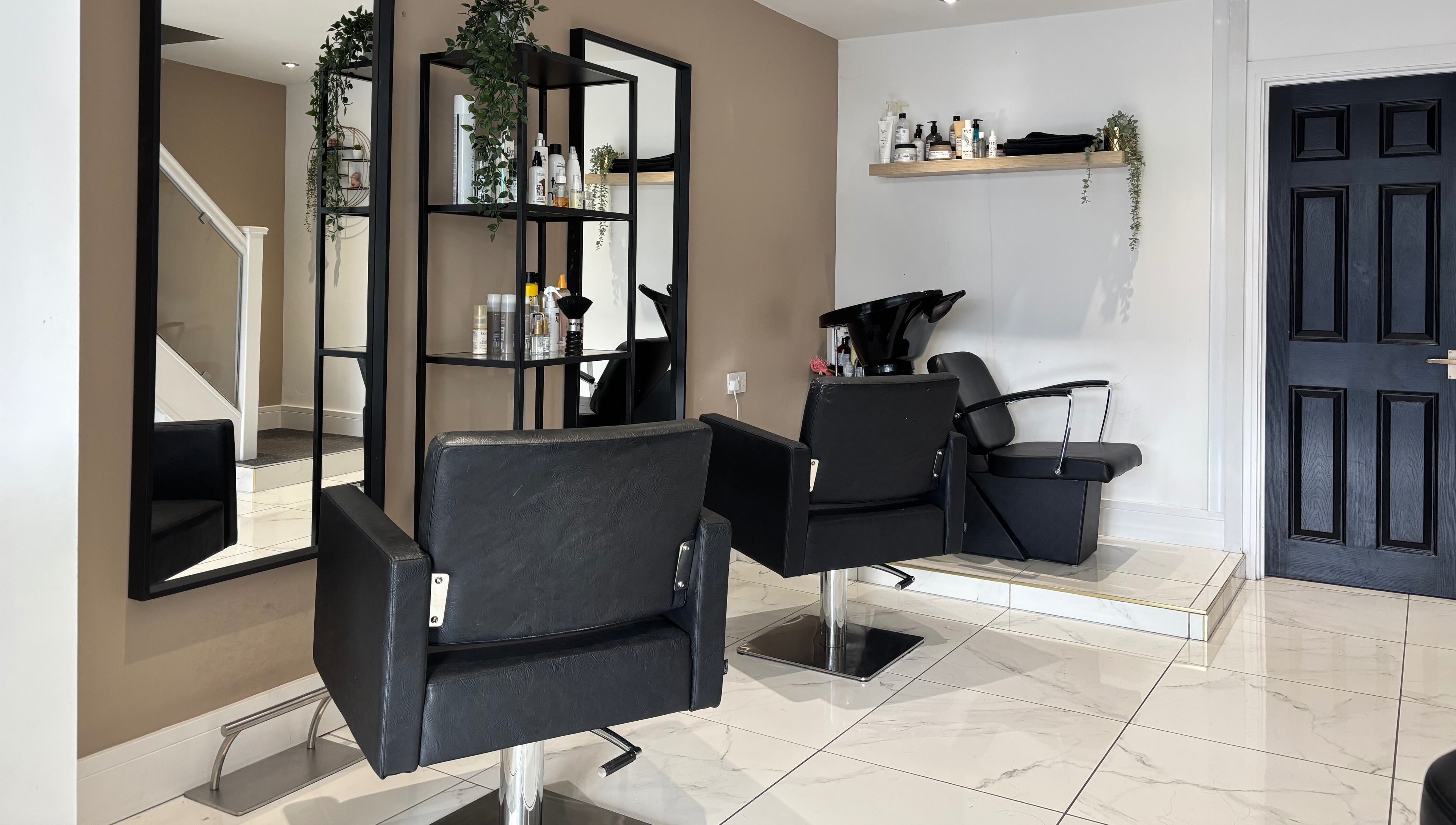 Modern salon interior at Picture Me Prestige, Hyde, England, GB, featuring sleek chairs and contemporary decor.