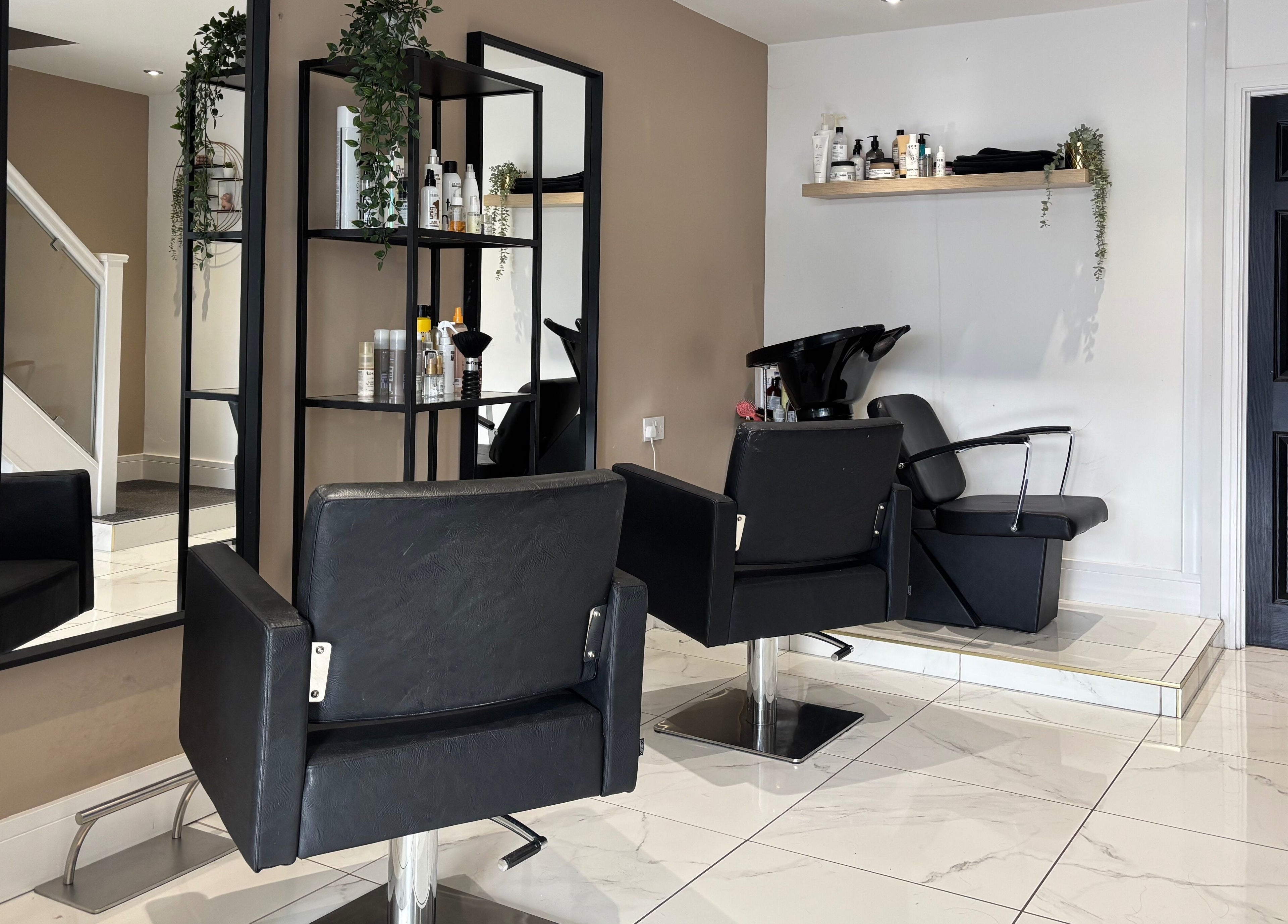 Modern salon interior at Picture Me Prestige, Hyde, England, GB, featuring sleek chairs and contemporary decor.